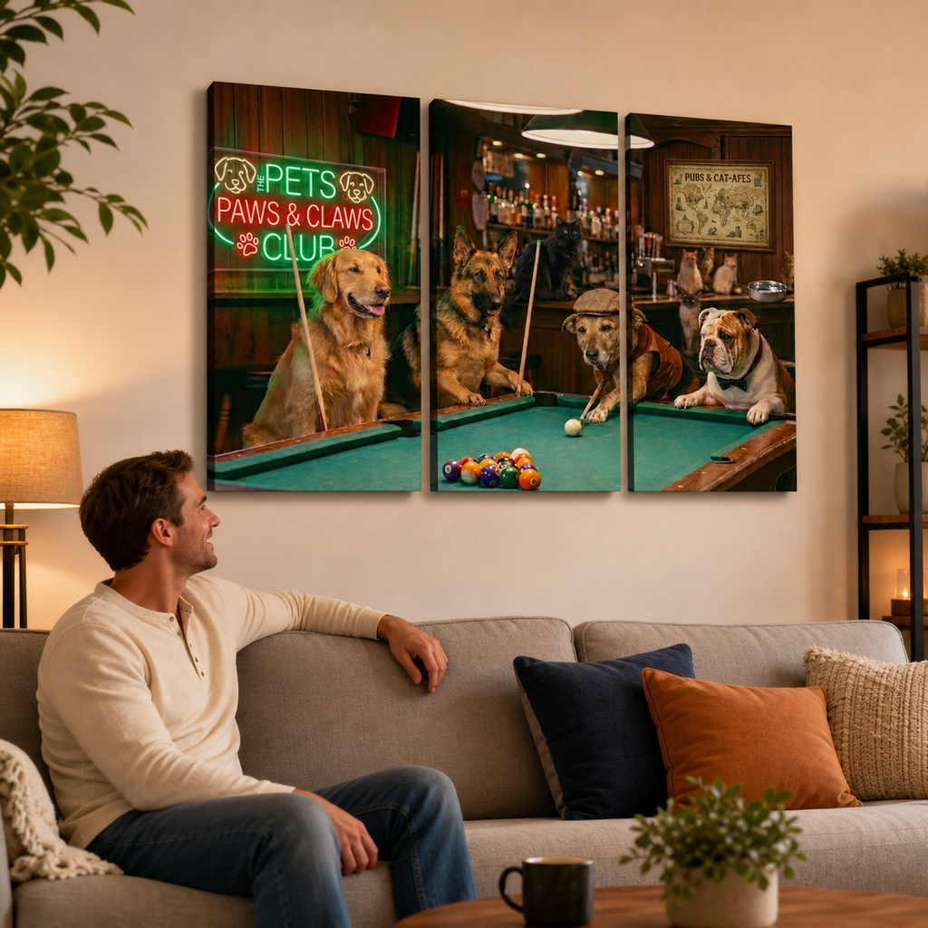 A man sits on a beige sofa in a living room, looking at a three-panel canvas wall art print depicting dogs playing pool in a bar scene. The print includes a neon sign reading 'Pets Paws & Claws Club'.