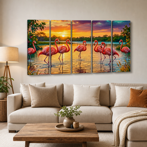 A five-panel canvas wall art set depicting a sunset flamingo marsh scene, displayed on a beige wall above a modern beige sectional sofa in a styled living room.