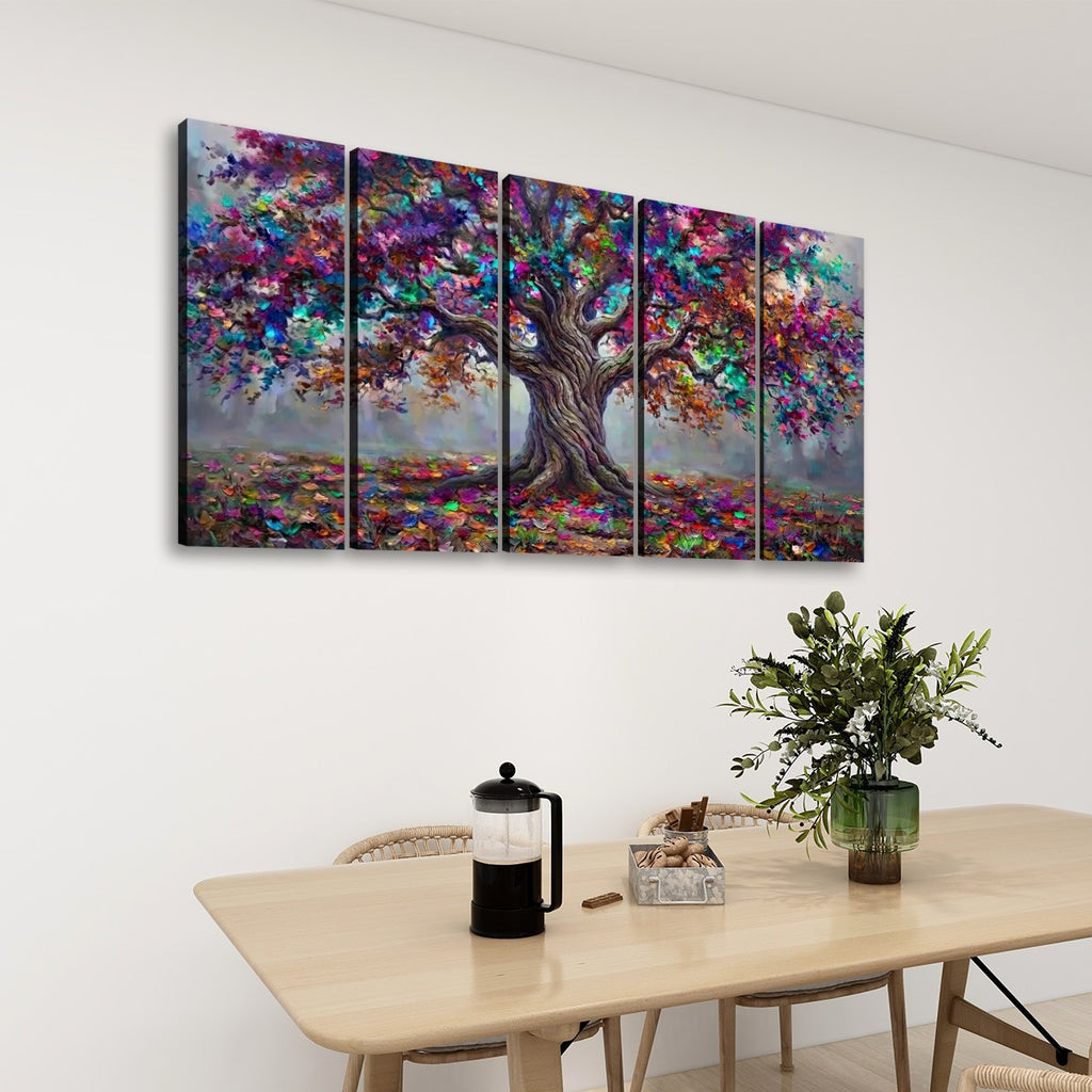 A five-panel canvas wall art set depicting a colorful, textured tree with purple, blue, pink, and green foliage, displayed on a white wall above a light wood dining table with a vase of greenery.