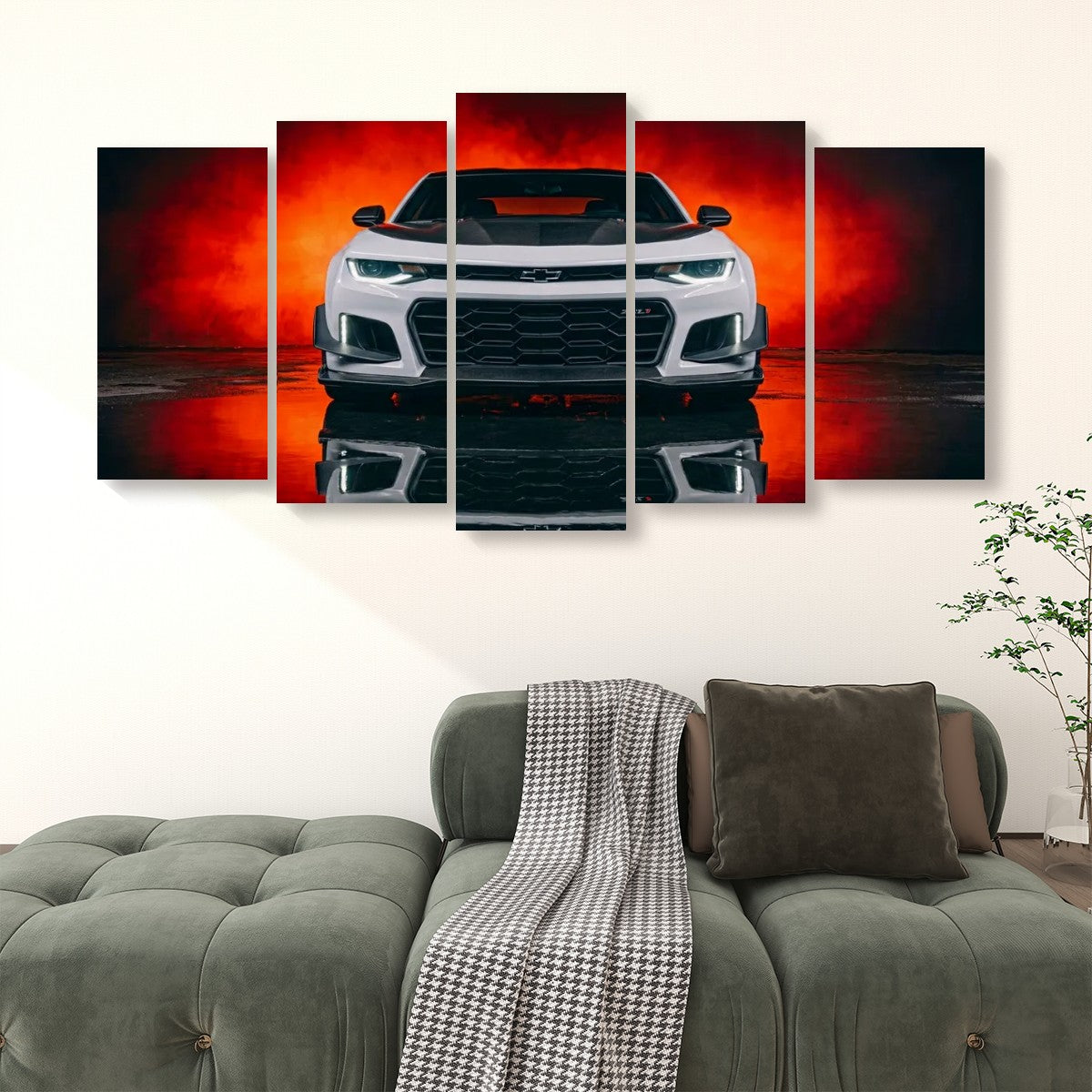 A 5-panel canvas wall art set depicting a white Camaro sports car against a dramatic red and black smoky background, displayed on a wall above a green sofa in a living room setting.