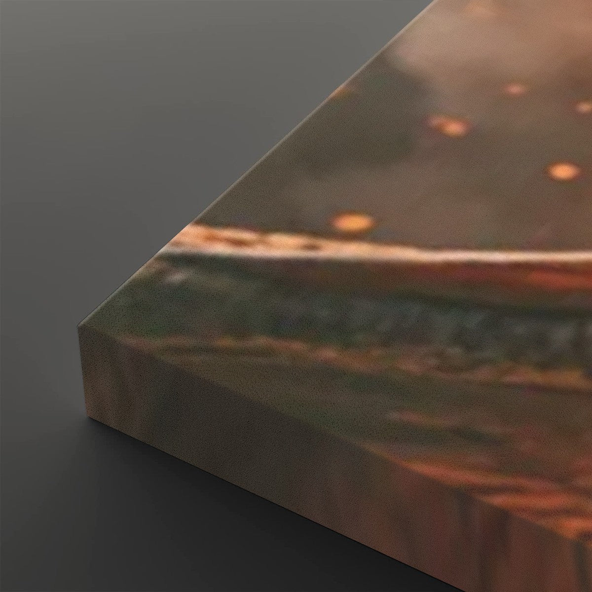 A close-up of a rectangular canvas or print showing an abstract landscape-like scene with warm brown, orange, and muted green tones, photographed against a dark gray background.