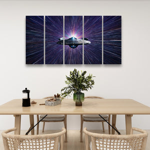A five-panel canvas wall art set depicting the Star Wars Millennium Falcon in a purple and blue starburst space scene, displayed on a white wall above a wooden dining table with chairs.