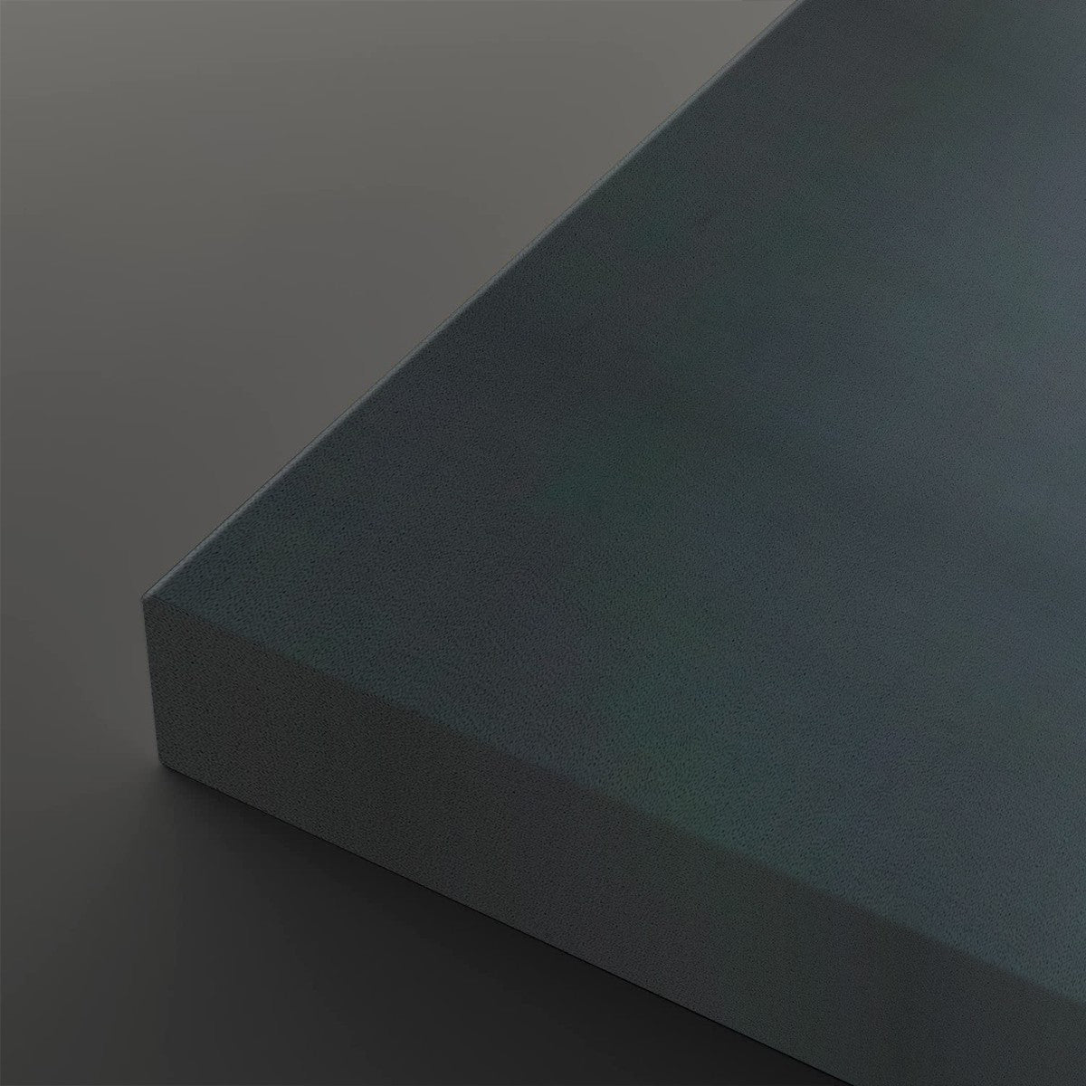 A close-up studio shot of a rectangular panel or board corner, shown at an angle against a dark gray background. The surface has a subtle iridescent or oil-slick-like finish shifting between blue, teal, and gray tones.