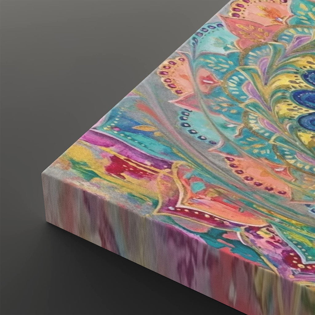 A close-up angled view of a square canvas print showing a colorful abstract mandala design with swirling teal, pink, yellow, purple, and blue patterns on a dark gray background.