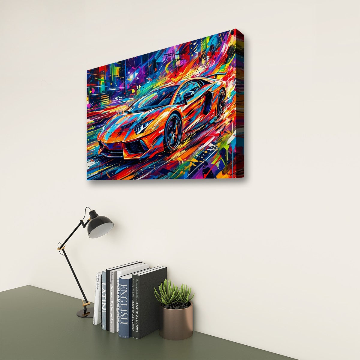 A colorful canvas wall art print showing a stylized sports car in a neon city scene, displayed on a light wall above a desk with books, a lamp, and a small plant.