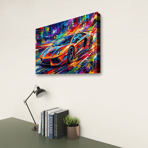 A colorful canvas wall art print showing a stylized sports car in a neon city scene, displayed on a light wall above a desk with books, a lamp, and a small plant.