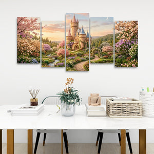 A five-panel canvas wall art set depicting a fantasy castle in a floral landscape, displayed on a white wall above a styled dining table with books, a vase, and a basket.