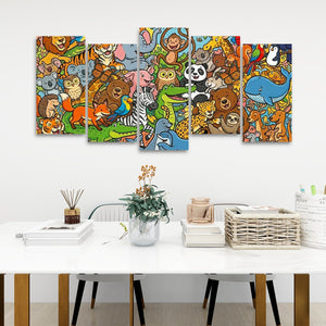 A 5-panel canvas wall art set featuring a colorful cartoon jungle animal scene, displayed on a white wall above a modern white table with decorative items.