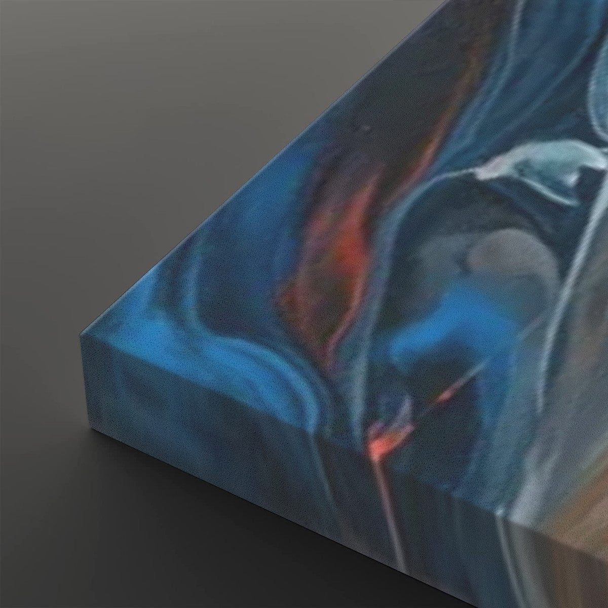 A close-up of a rectangular art print or canvas showing an abstract marbled design with swirling blue, black, white, and orange-red tones, photographed against a dark gray background.