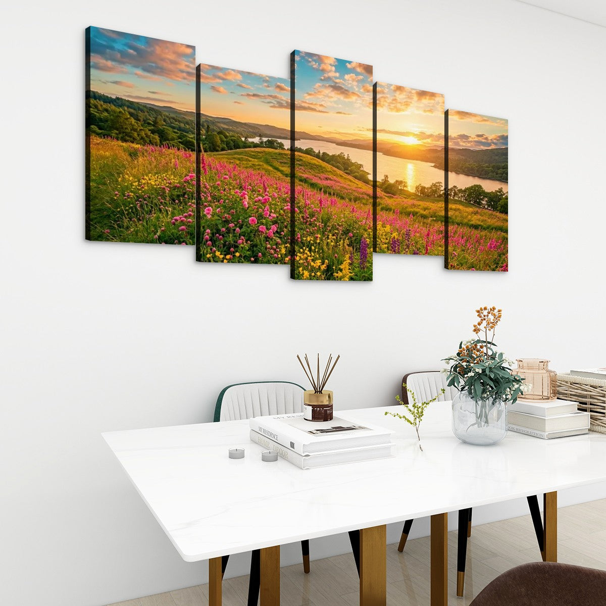 A five-panel canvas wall art set depicting a colorful mountain landscape at sunset, displayed on a white wall above a dining table in a modern room setting.