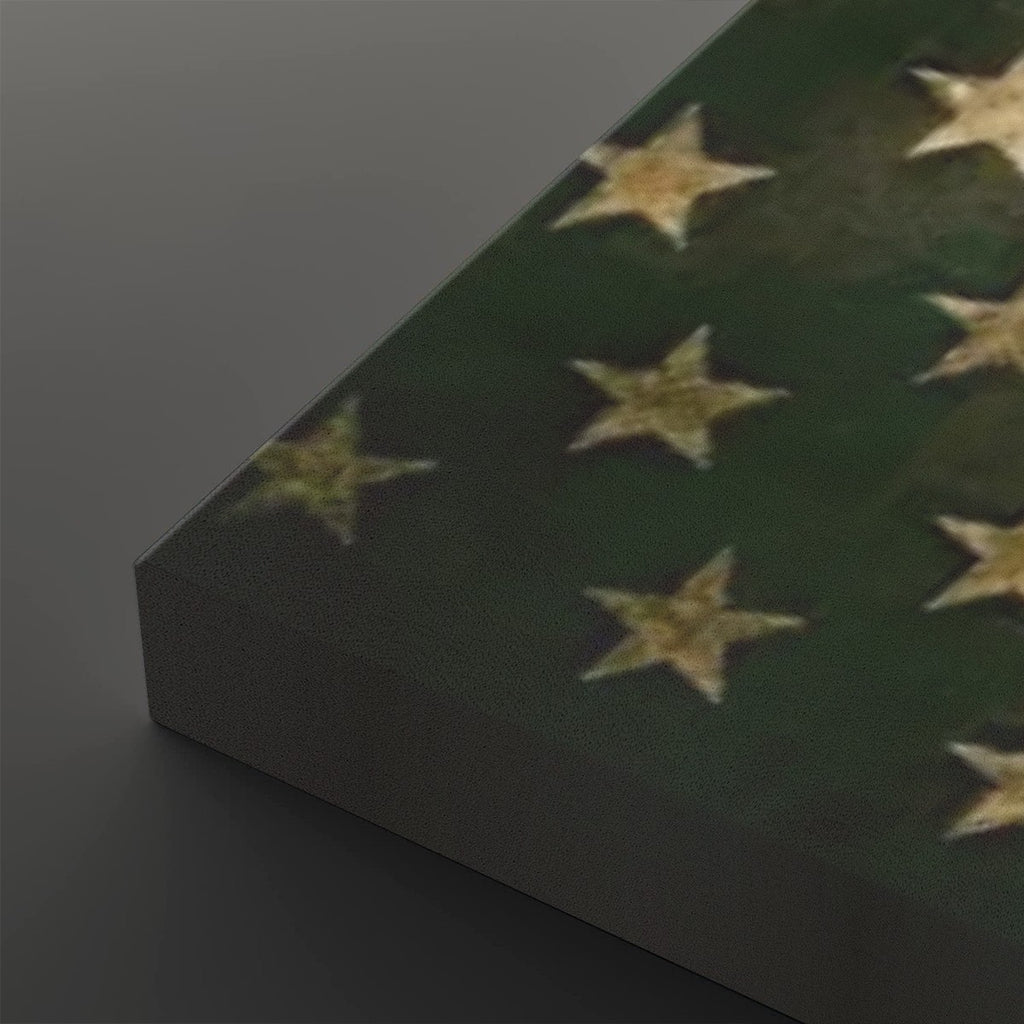 A close-up of a dark green canvas or panel featuring a distressed pattern of gold stars, shown at an angle against a dark gray background.