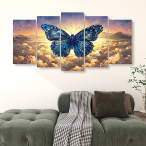 A five-panel canvas wall art set depicting a large blue butterfly over a glowing sky and clouds, displayed above a green sofa in a living room setting.