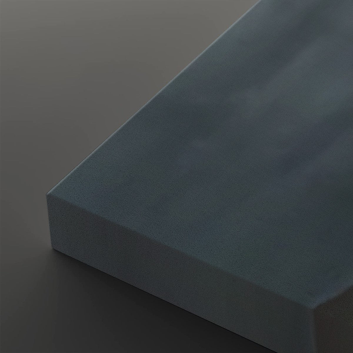 A close-up of a rectangular blue-gray textured block or panel on a dark gray background.