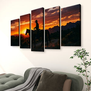 A five-panel canvas wall art set depicting a cowboy riding a horse at sunset, displayed on a white wall above a green sofa in a living room setting.