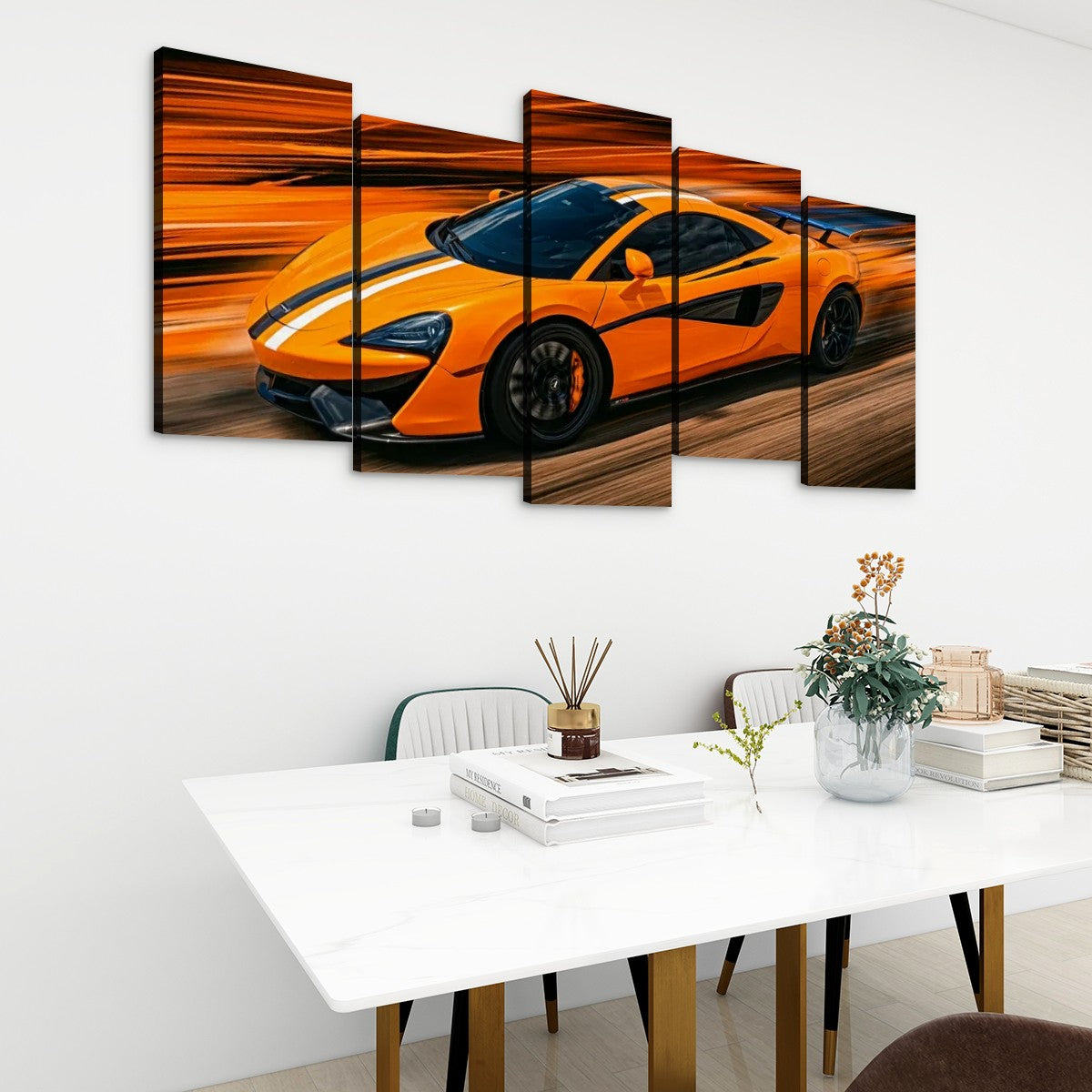 A 5-panel canvas wall art set depicting an orange sports car with white racing stripes, displayed on a white wall above a modern dining table with books and a vase.