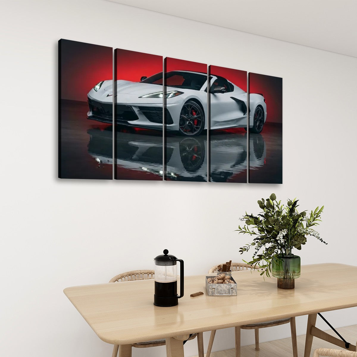A five-panel canvas wall art set depicting a white sports car on a reflective dark surface with a red background, displayed above a dining table in a modern room setting.