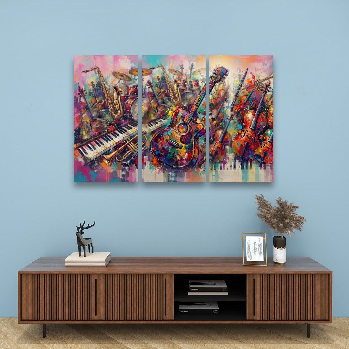 A three-panel canvas wall art set depicting a colorful, textured painting of musical instruments including guitars, violins, pianos, and brass instruments, displayed on a light blue wall above a wooden console table.