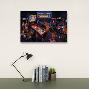 A framed wall art print depicting a retro arcade scene with dogs playing pinball machines, displayed above a desk with a black lamp, books, and a small potted succulent against a light beige wall.
