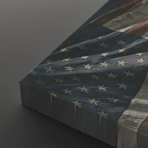 A close-up angled view of a canvas print showing part of an American flag design with a distressed texture, set against a dark gray background.