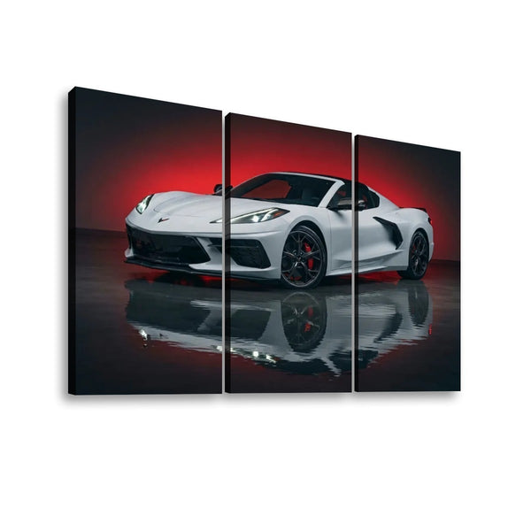 Three-panel canvas wall art showing a white sports car on a dark reflective surface with a red gradient background, displayed against a light gray wall.