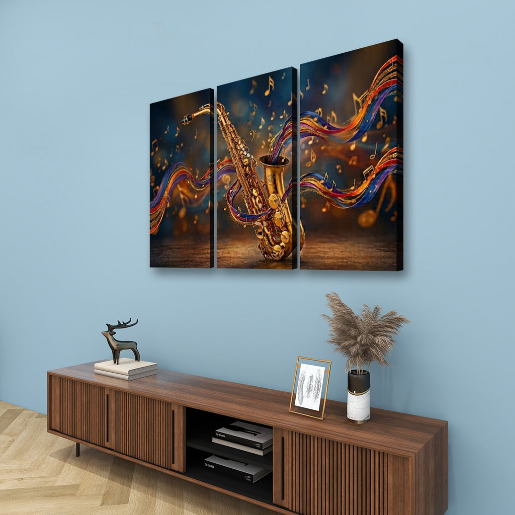 A three-panel canvas wall art set depicting a golden saxophone with colorful flowing musical notes, displayed above a wooden console table against a light blue wall.