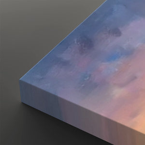 A close-up of a square canvas print showing its wrapped edge and textured abstract painted surface in soft blue, lavender, pink, and peach tones against a dark gray background.