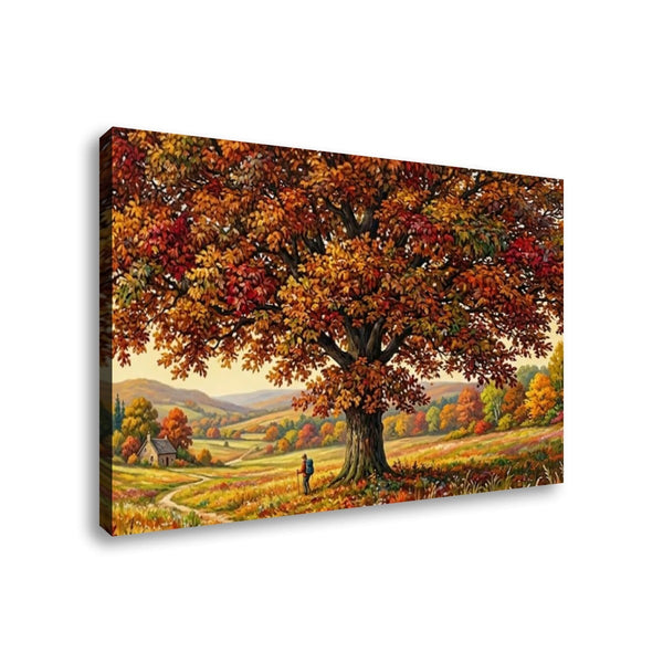 A rectangular canvas wall art print showing an autumn landscape with a large tree in full red, orange, and yellow foliage, rolling hills, a small cabin, and a tiny person walking beneath the tree. The canvas is photographed at a slight angle against a plain white background.