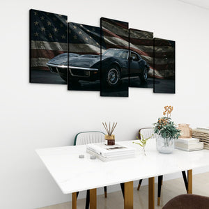 A five-panel canvas wall art set depicting a black 1972 Corvette sports car in front of a distressed American flag, displayed on a white wall above a dining table in a modern room setting.