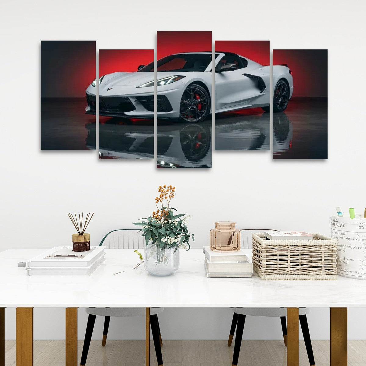 A multi-panel canvas wall art set depicting a white sports car with red accents, displayed above a white dining table in a modern room setting.