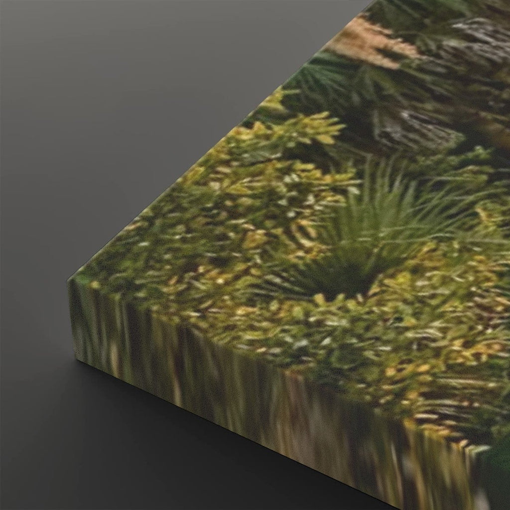 A close-up angled view of a rectangular canvas or panel printed with a dense green mossy or forest-like texture, set against a dark gray background.
