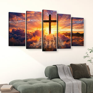 A five-panel canvas wall art set depicting a dramatic sunset sky with clouds and a large cross silhouette, displayed above a green sofa in a living room setting.