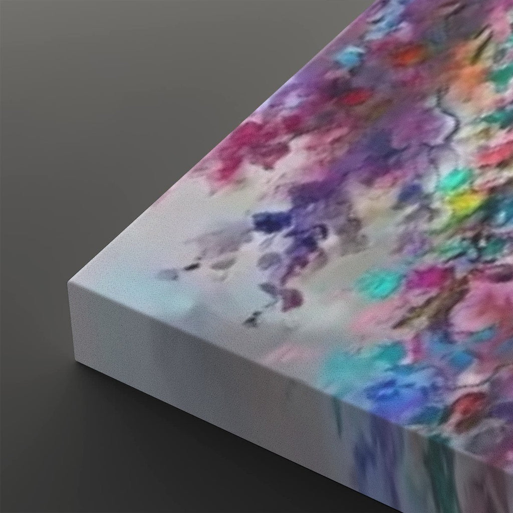 A close-up of a rectangular canvas print showing its wrapped edge, featuring an abstract watercolor-style floral or marbled pattern in pink, purple, blue, teal, yellow, and red on a white base, set against a dark gray background.