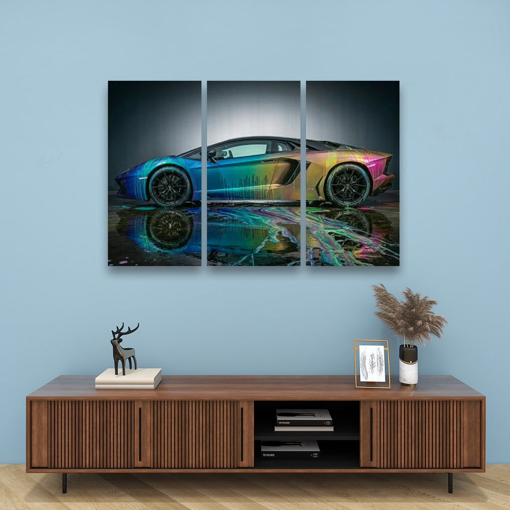 A three-panel canvas wall art print depicting a colorful sports car with a reflective watercolor effect, displayed on a light blue wall above a wooden console table with decorative items.