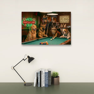 A rectangular wall art print showing three dogs playing pool in a bar scene, mounted on a light wall above a desk with a black lamp, books, and a small plant.
