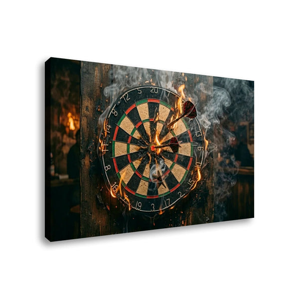 A rectangular wall art print or canvas showing a burning dartboard with darts stuck in the center, smoke, and flames, photographed against a plain white background.