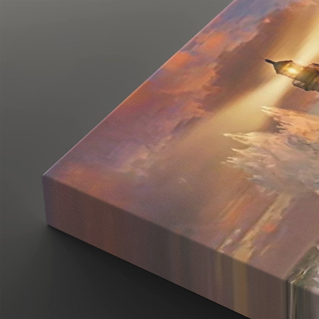 A close-up of a rectangular canvas print showing a painted sunset or sunrise scene with warm orange, pink, and gold tones, photographed on a dark gray background.