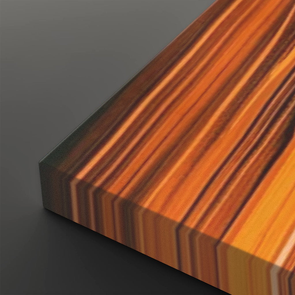 A close-up of a rectangular wooden board or slab with a striking striped wood grain pattern in warm orange, brown, and golden tones, shown on a dark gray background.