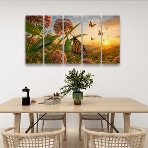 A four-panel canvas wall art set depicting a butterfly and caterpillar scene with wildflowers and a sunset, displayed on a white wall above a dining table with chairs.