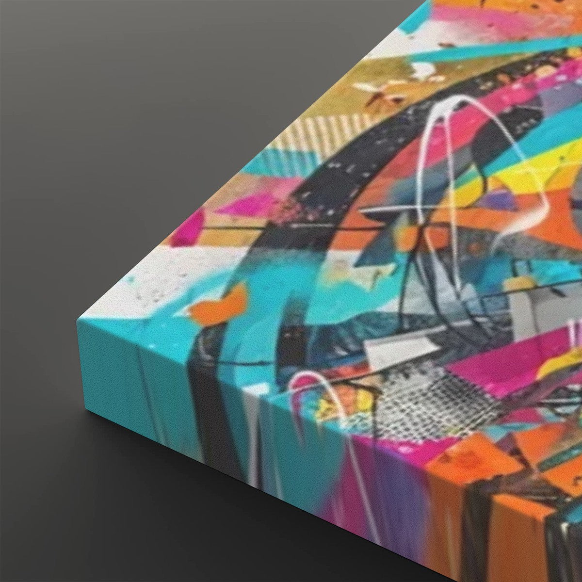 Abstract canvas wall art with a bold multicolor design, featuring turquoise, pink, orange, yellow, black, and white brushstrokes and splatters, shown at an angle on a dark gray background.