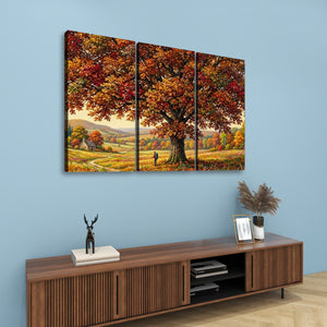 A three-panel canvas wall art set depicting a large autumn tree in a scenic landscape, displayed on a light blue wall above a wooden console table with decorative items.