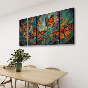 A four-panel canvas wall art set depicting vibrant orange monarch butterflies over colorful swirling abstract backgrounds, displayed on a white wall above a light wood dining table with chairs and a green plant.