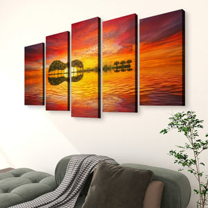 A five-panel canvas wall art set depicting a dramatic sunset over water with mirrored trees, displayed above a green sofa in a living room setting.