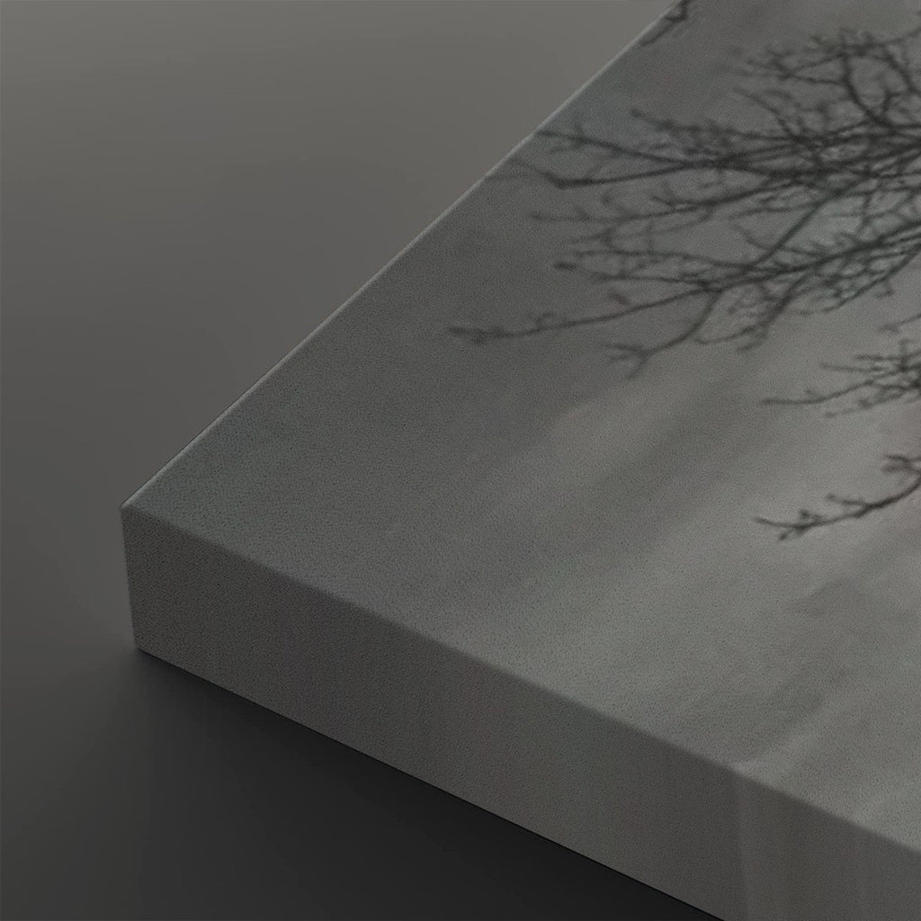 A close-up of a canvas wall art print showing the wrapped edge and textured surface, featuring a monochrome tree branch pattern on a gray background.