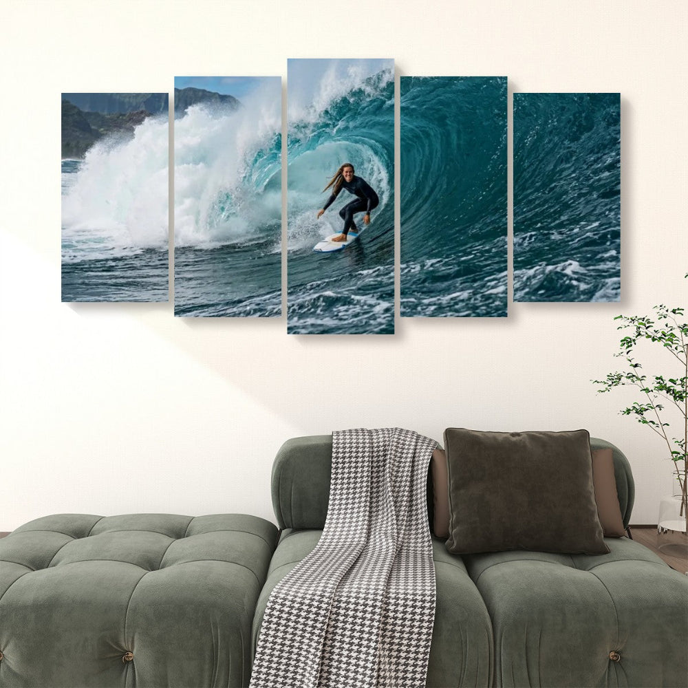 A five-panel canvas wall art set depicting a surfer riding a large blue ocean wave, displayed above a green sofa in a living room setting.
