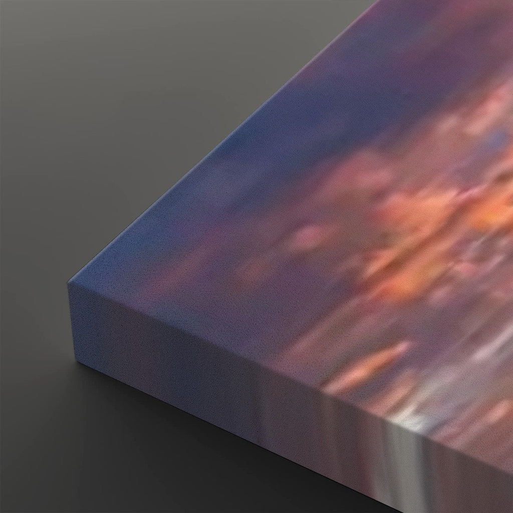 A close-up of a rectangular canvas or print showing an abstract painted scene with blue, purple, pink, and orange tones, photographed on a dark gray background.