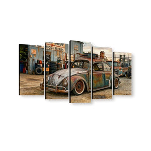 A multi-panel canvas wall art print depicting a vintage rusted blue and orange Volkswagen Beetle in a rusty auto repair shop, shown against a plain white background.