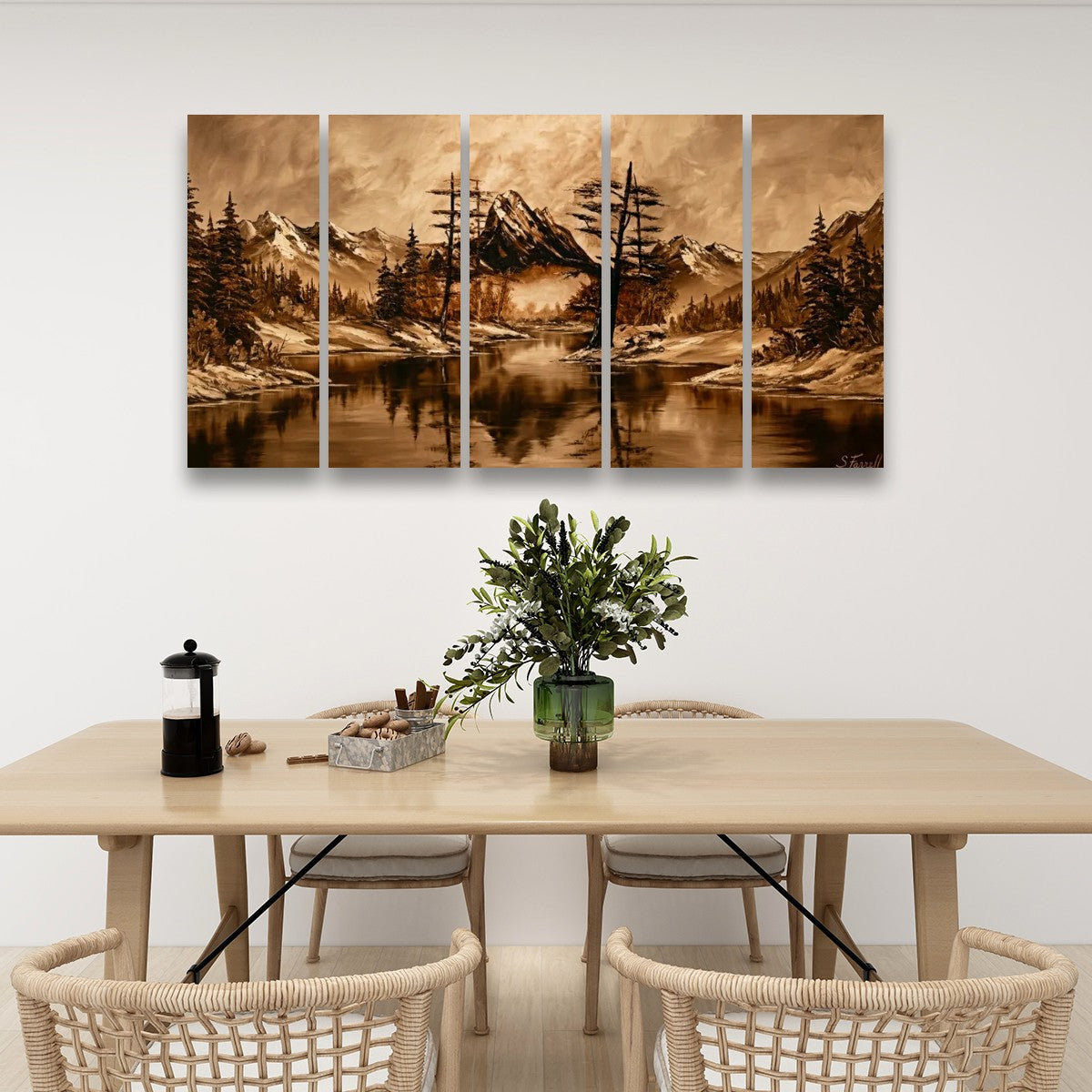 A four-panel canvas wall art set depicting a scenic mountain lake landscape in warm sepia tones, displayed above a light wood dining table with woven chairs in a modern dining room setting.