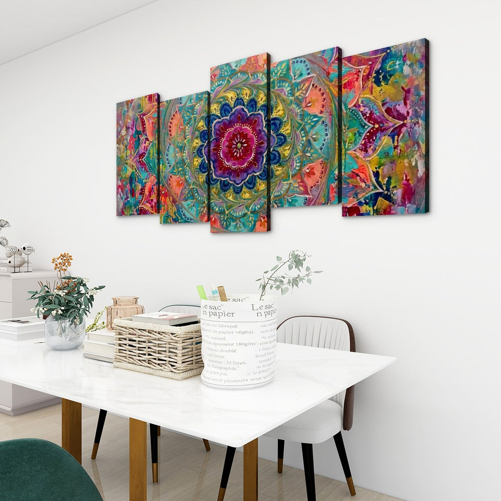 A five-panel canvas wall art set featuring a vibrant, colorful mandala and abstract floral design, displayed on a white wall above a dining table in a modern room setting.