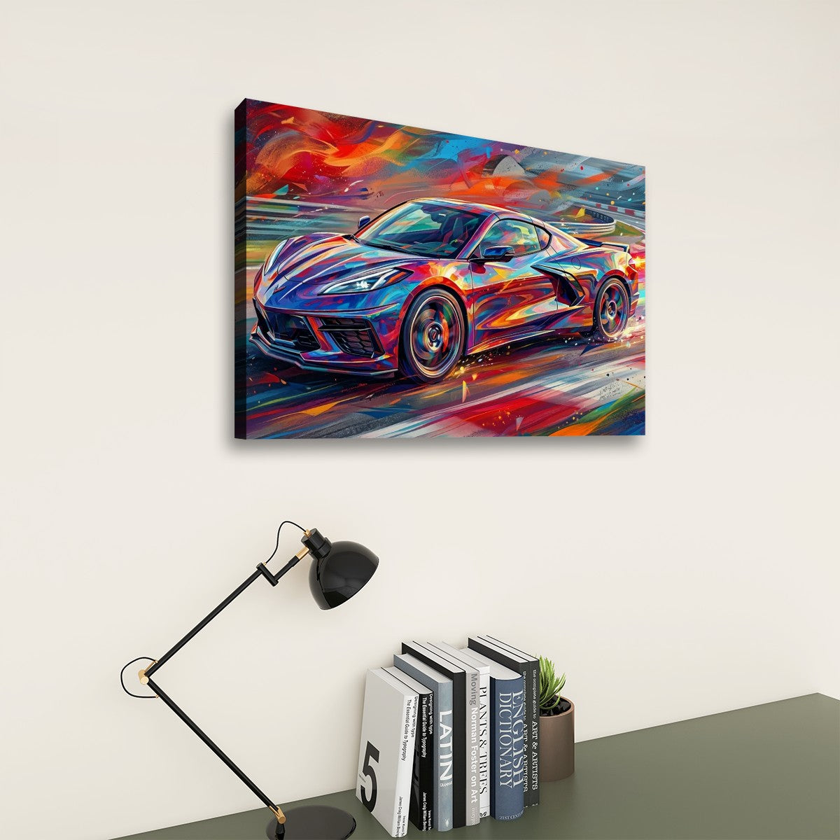 A colorful canvas wall art print depicting a sports car in an abstract, painterly style, displayed on a light beige wall above a desk with a black lamp and books.