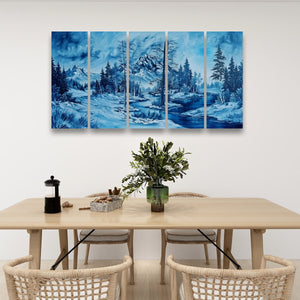 A five-panel canvas wall art set depicting a snowy mountain forest in shades of blue, hung above a light wood dining table with woven chairs and a green vase.